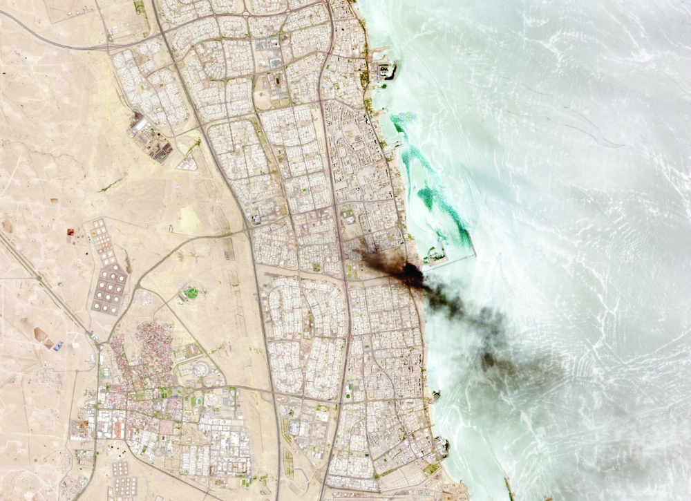 A satellite image shows smoke billowing near an oil facility in Ahmadi Governorate, Kuwait. — Reuters