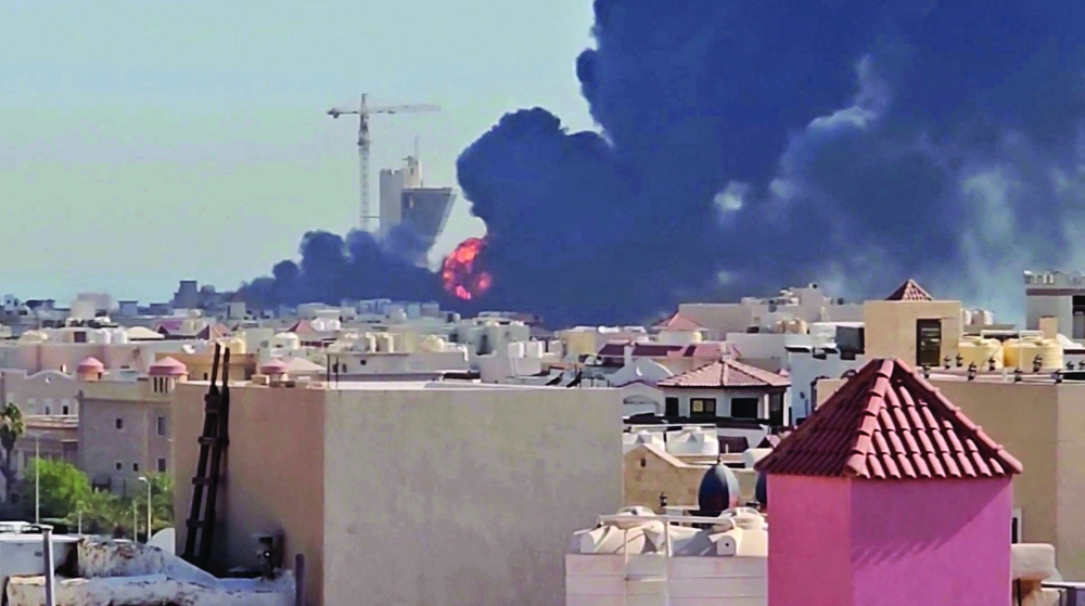 Smoke billows near the oil facility in Mangaf, Kuwait. — Reuters