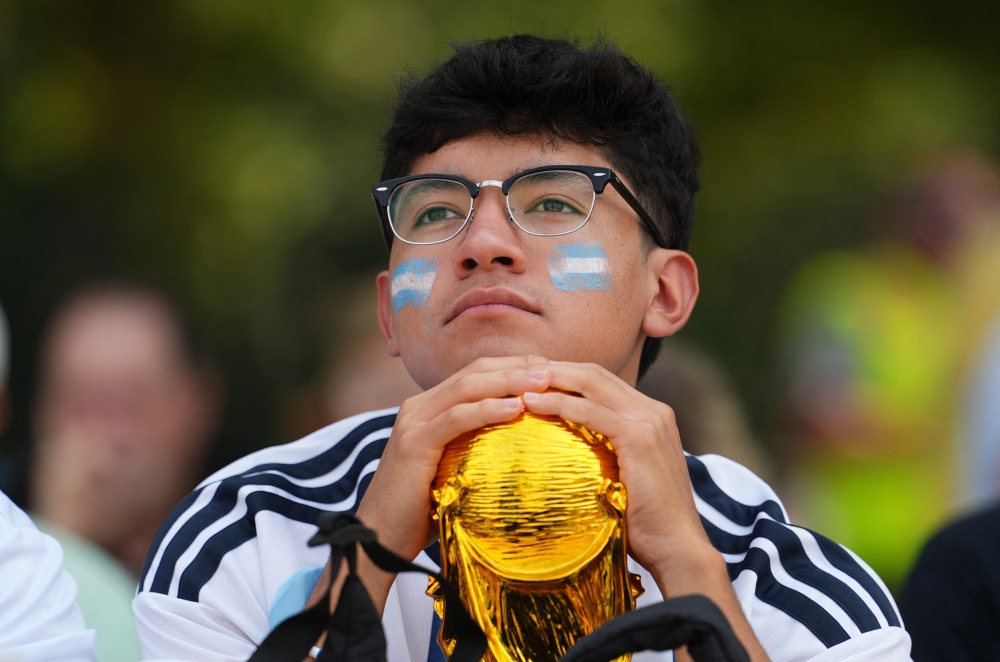  
An Argentina fan with a replica of the World Cup trophy. — AFP  