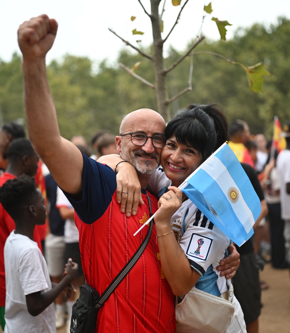 An Argentina fan and a Spain fan embrace on the final. — Reuters 