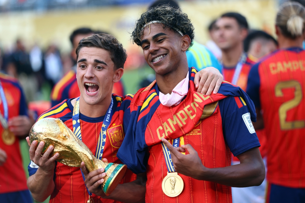  
Spain's Lamine Yamal and Gavi celebrate with the World Cup trophy after winning the World Cup  