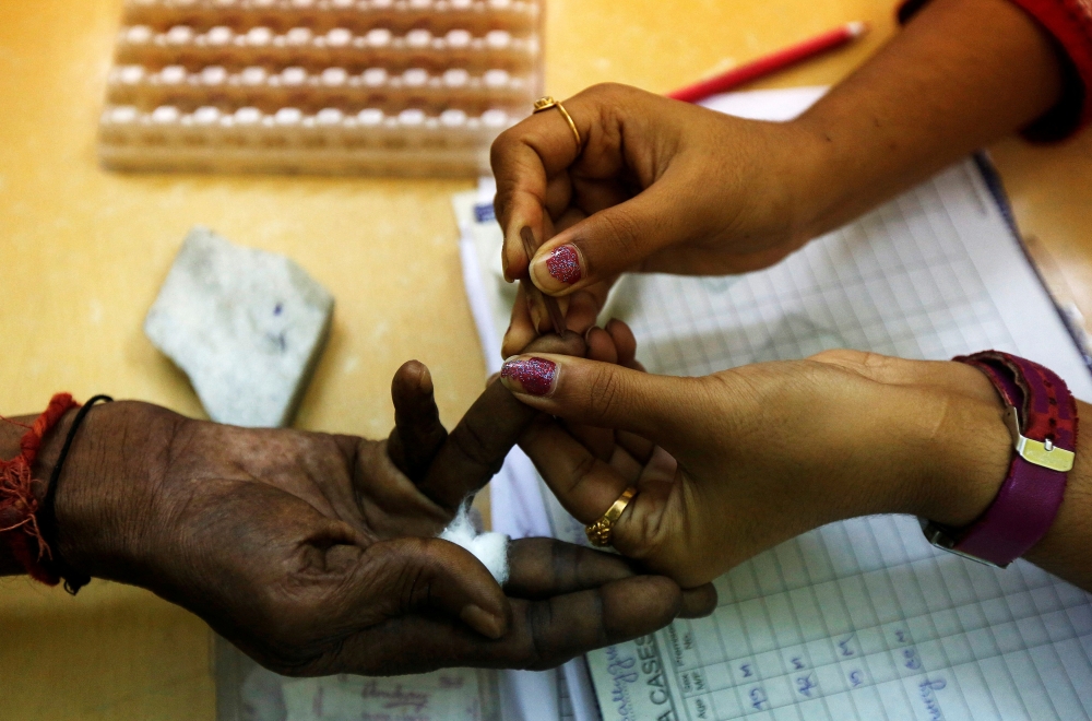 A government health worker collects a blood sample from a patient at a dengue detention centre in Kolkata, India