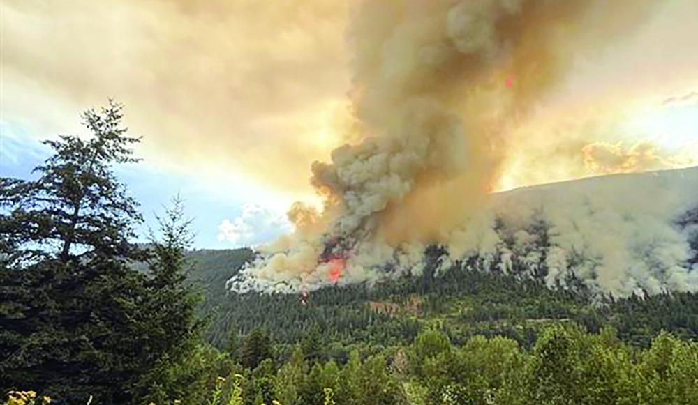 Smoke rises from the southern flank of the Brunswick Creek wildfire near North Bend, Canada. — Reuters