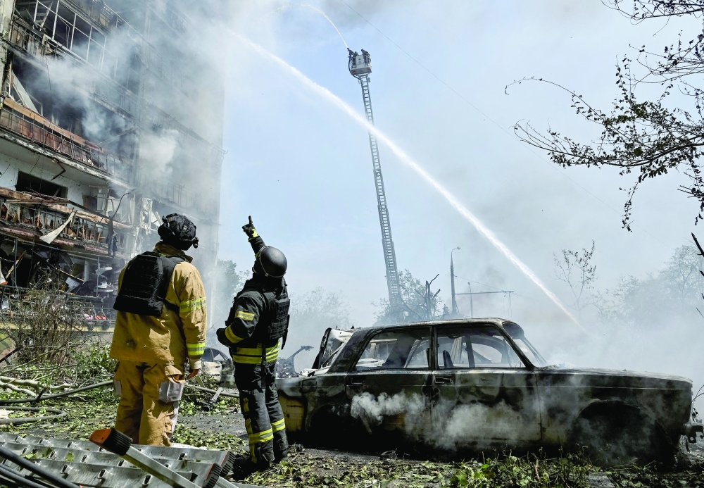 Rescuers work at a site of an apartment building hit by Russian air strike in Zaporizhzhia, Ukraine. — Reuters 