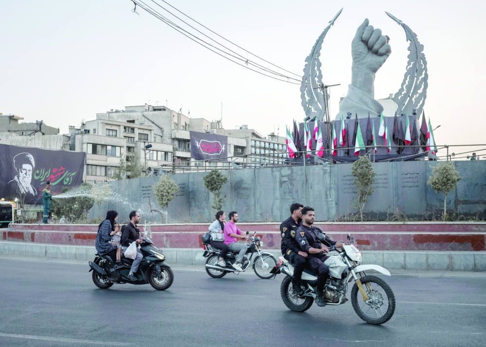 Traffic passes Enghelab Square, in Tehran. — NYT file photo