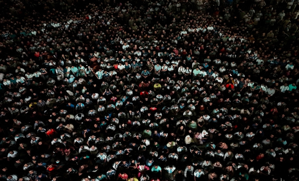  An aerial view shows football fans watching a live broadcast of the 2026 World Cup final between Argentina and Spain at Dhaka University in Dhaka 
