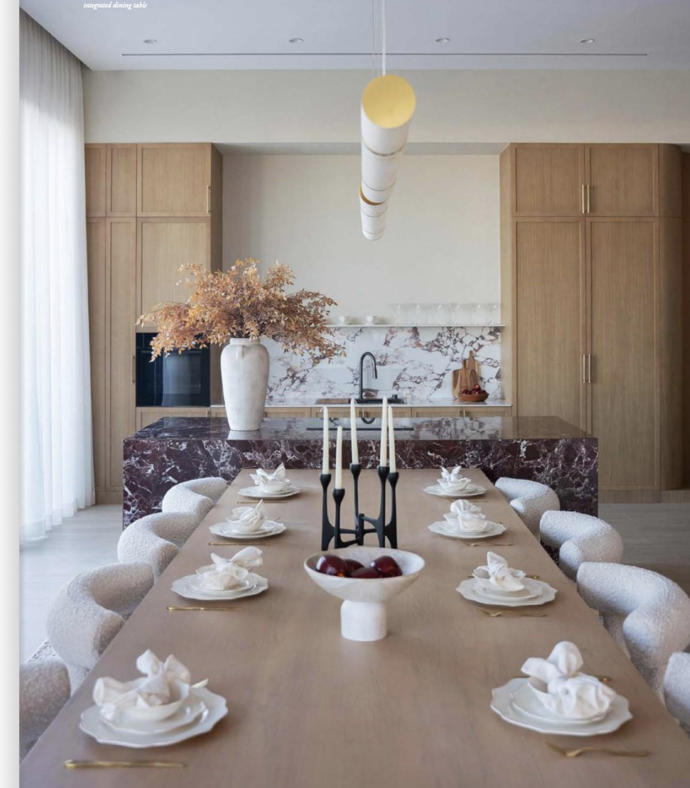 The kitchen features a burgundy marble island with an integrated dining table