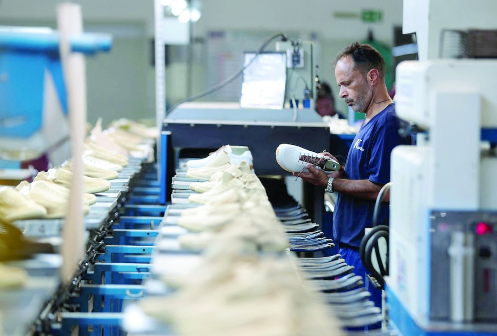 
A worker inspects a shoe on a production line at Brazilian footwear factory in Sao Paulo, Brazil. — Reuters 