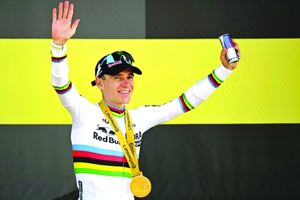  Evenepoel celebrates on the podium after winning the 16th stage. — Reuters