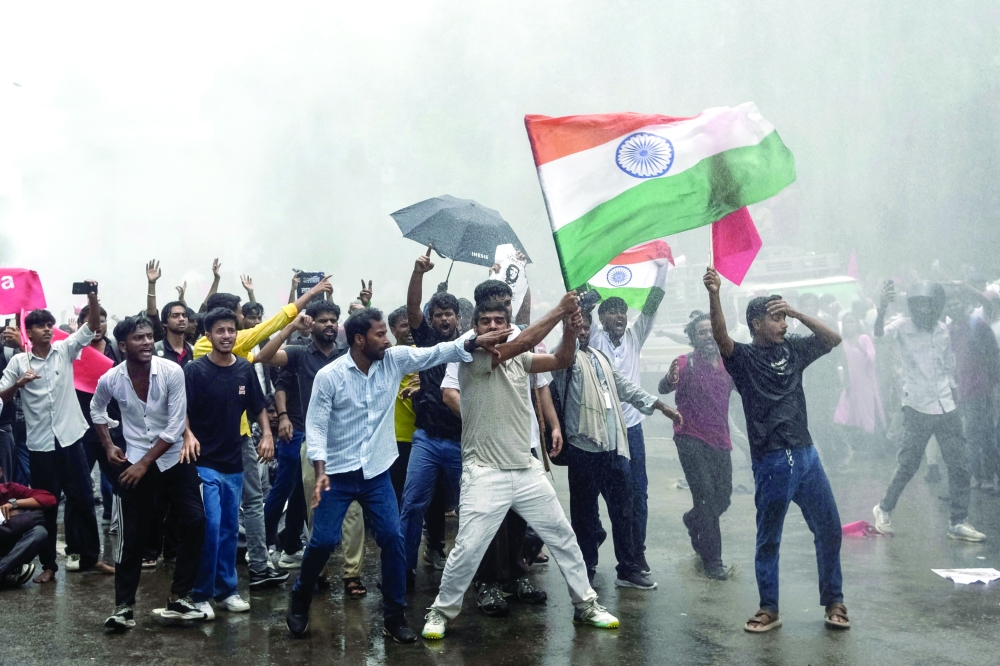 Demonstrators carrying the Indian national flag shout slogans during a protest march in Patna demanding the resignation of India’s Education Minister Dharmendra Pradhan over alleged NEET exam irregularities. — AFP