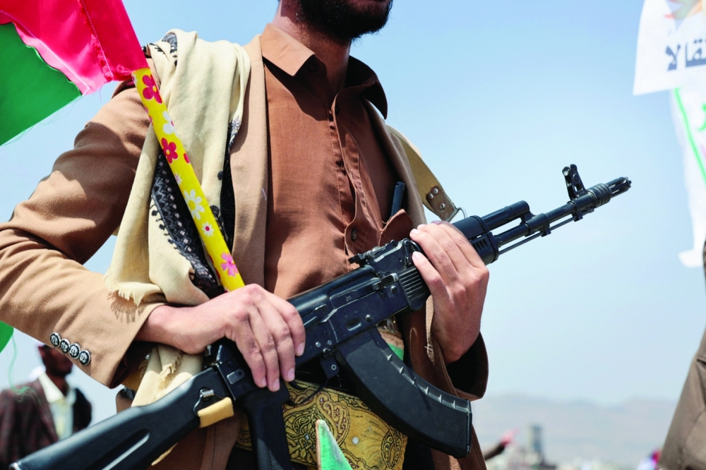A student holds a rifle as he parades at Sanaa University campus to show support for the Ansar Allah amid an escalation with Saudi Arabia, in Sanaa, Yemen, on Wednesday. — Reuters
