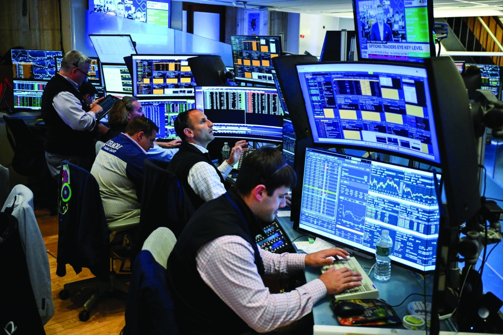 Traders work on the floor of the New York Stock Exchange (NYSE) in New York. - AFP