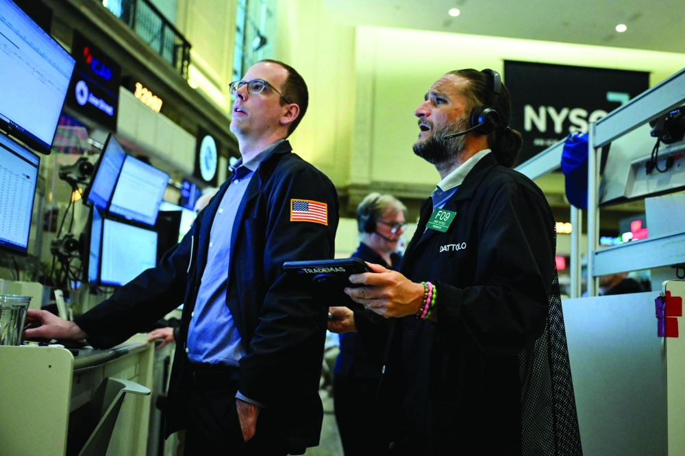 Traders work on the floor of the New York Stock Exchange (NYSE) in New York. - AFP