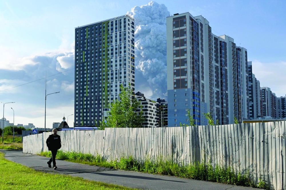Residential buildings amidst smoke from a warehouse for a Russian e-commerce giant near St Petersburg after being hit by Ukrainian drones triggering a fire that sent smoke pouring over the historic city. - AFP
