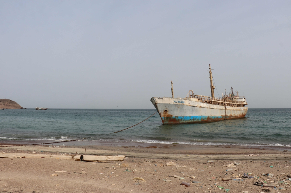 A photo taken from the Yemeni coast southwest of the city of Taiz shows a vessel anchored at Bab al-Mandab Strait, in the Red Sea, on July 24, 2026. 