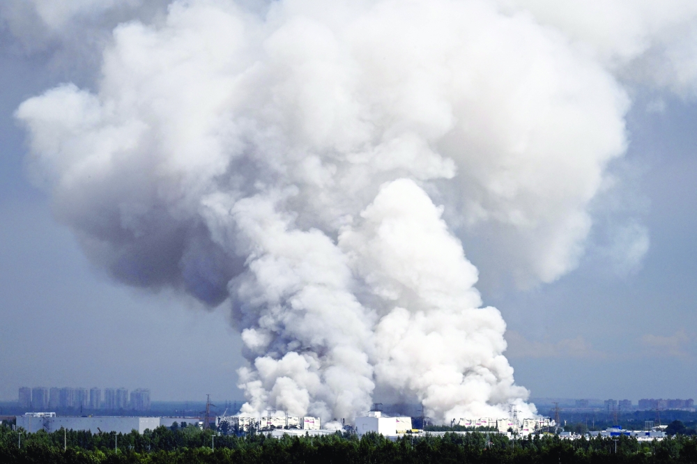 Smoke rises from a warehouse near Saint Petersburg after being hit by Ukrainian drones. — AFP