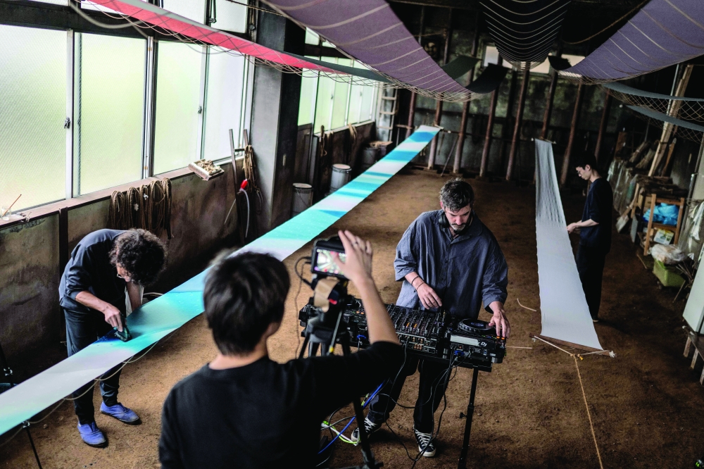 Login.jp, travels across Japan filming DJ performances in unexpected locations, including dye workshops, tofu shops, rice fields and rural trains.— AFP