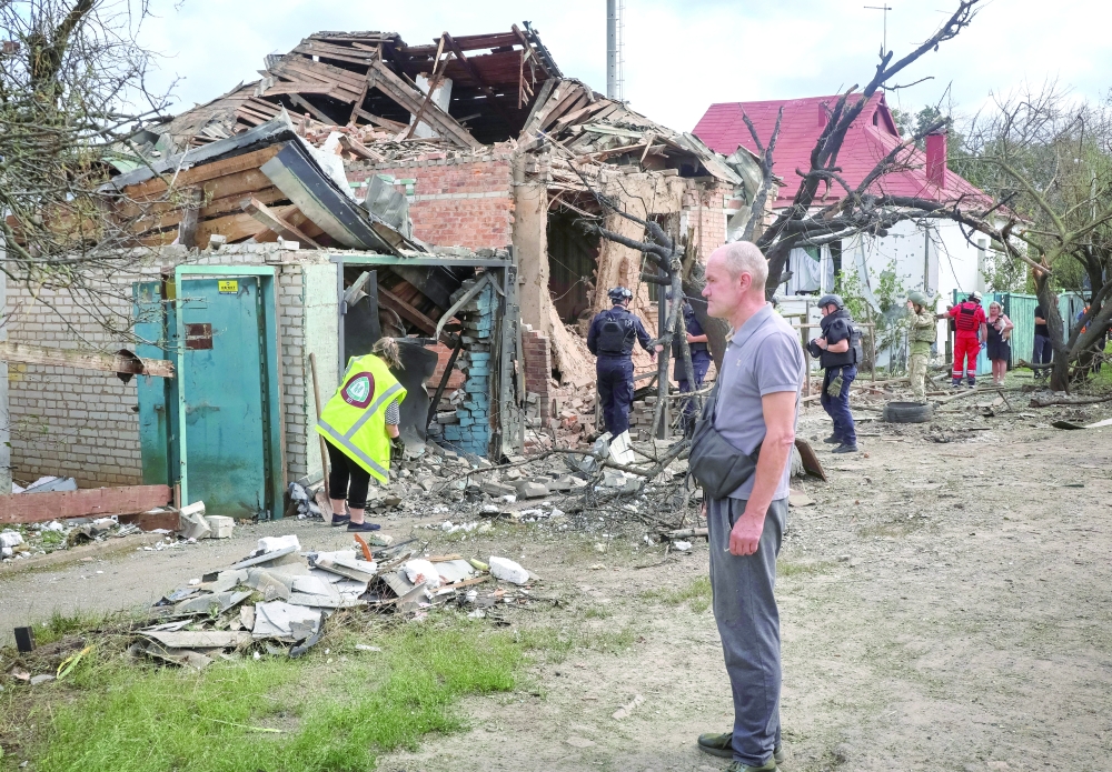 A residents stands at a site of the house hit during a Russian drone strike, amid Russia's attack on Ukraine, in Kharkiv region, Ukraine July 26, 2026. Picture taken with a mobile phone. REUTERS/Vyacheslav Madiyevskyy