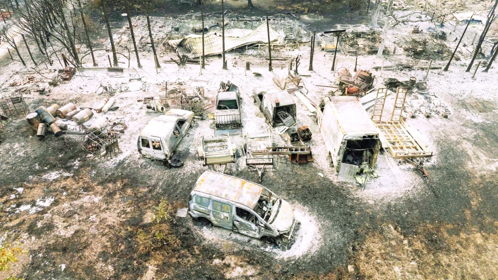 This aerial view shows burnt cars following a wildfire in Le Porge, south-western France. — AFP