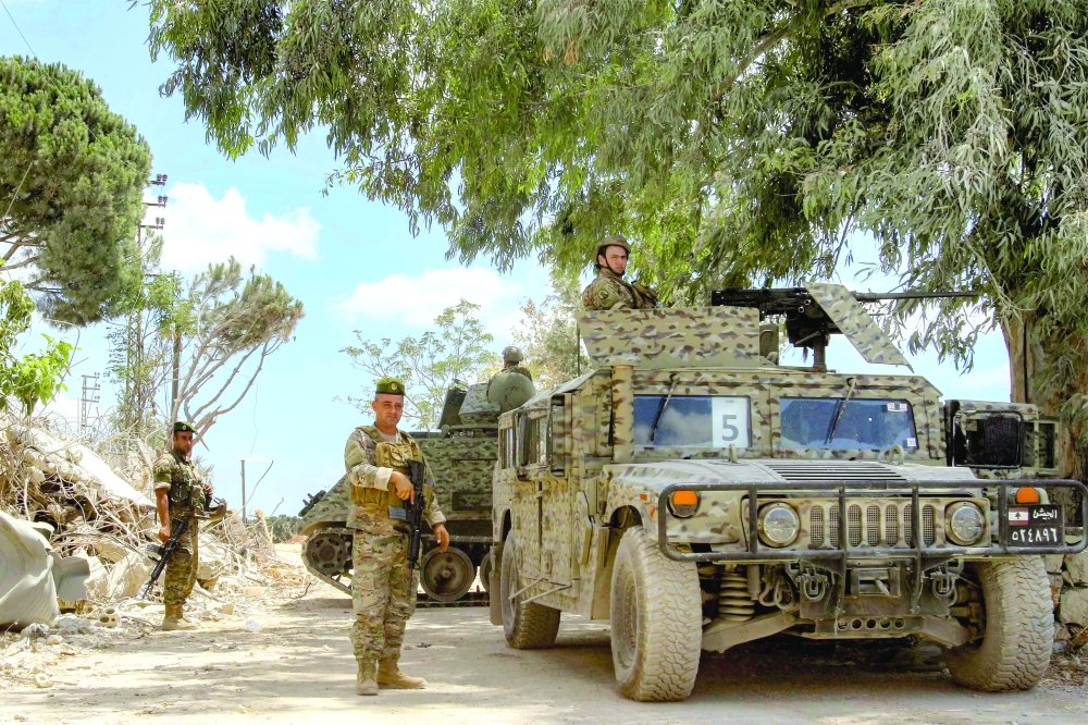 Lebanese army soldiers patrol the village of Zawtar al-Gharbiyeh in southern Lebanon on July 26, 2026. Lebanon's army had on July 21 began deploying to Zawtar al-Gharbiya as part of a US-sponsored framework agreement signed by Lebanon and Israel last month. Under the deal, the army is to disarm Hezbollah and the Israeli military is to withdraw from "pilot zones" where Lebanese troops will subsequently deploy. (Photo by MAHMOUD ZAYYAT / AFP) / Attention editors: AFP covers the war in the Middle East through its extensive regional network, including bureaus in Tehran, Jerusalem, and several neighboring countries. Since the start of the conflict, journalists have been working under increasingly restrictive conditions. Authorities in several countries have limited reporters' movements, photo and live video coverage from sensitive locations. Some governments and armed groups have banned images of missile or drone strikes and other security-related sites.