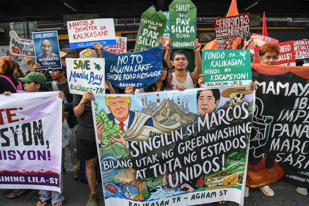 Protesters carrying placards march during a demonstration ahead of Philippine President Ferdinand Marcos’ State of the Nation Address at the House of Representatives in Quezon City, suburban Manila on July 27, 2026. (Photo by TED ALJIBE / AFP)
