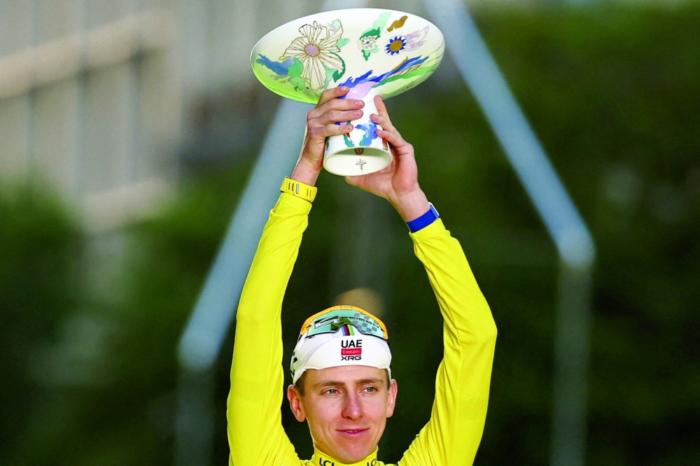 UAE Team Emirates - XRG's Slovenian rider Tadej Pogacar celebrates on the podium with the overall leader's yellow jersey after the 21st stage of the 113th edition of the Tour de France cycling race. — AFP