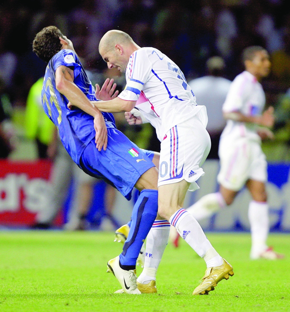 Italy's Marco Materazzi falls on the pitch after being head-butted by France's Zinedine Zidane (R) during their World Cup 2006 final soccer match