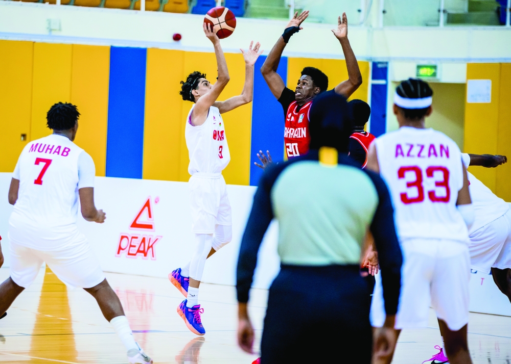 Oman and Bahrain players contest possession during their Gulf qualifiers match in Doha.