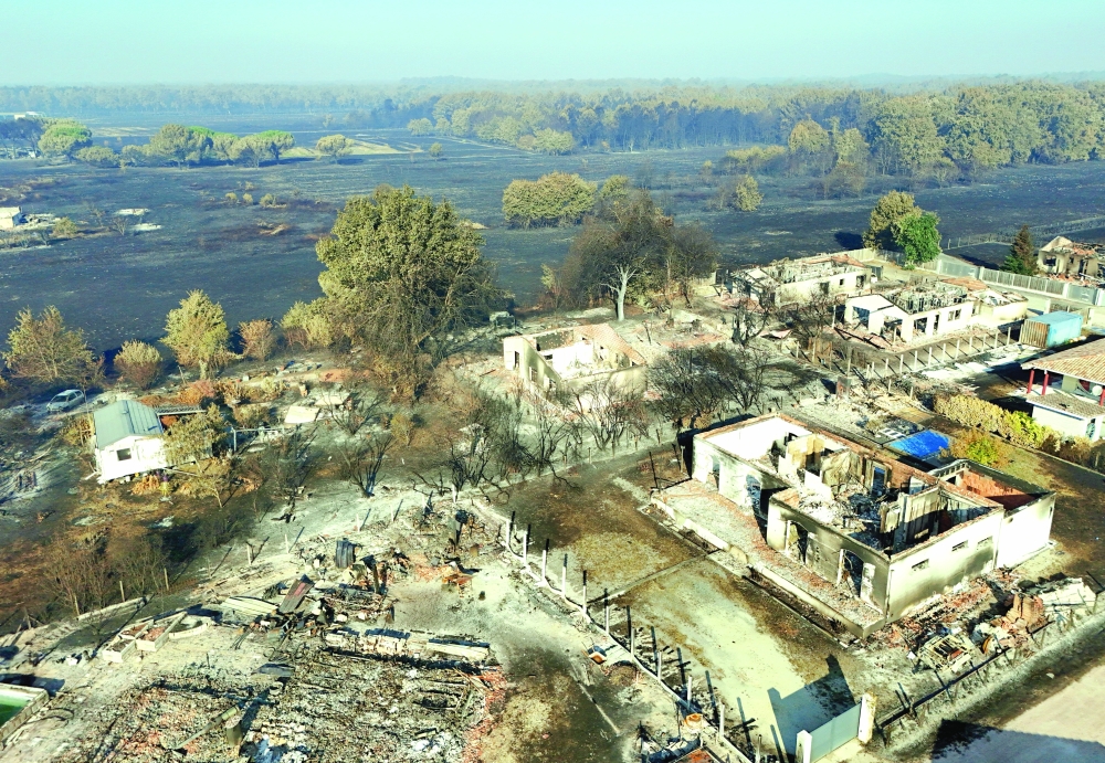 A drone view shows burnt buildings in an area affected by a wildfire in Biscarosse