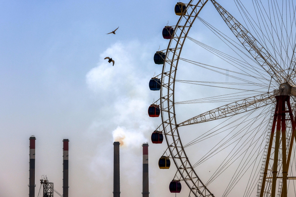 A large Ferris wheel is pictured near the Dora (Daura) Thermal Power Station in the Dora district of southern Baghdad on July 27, 2026. 