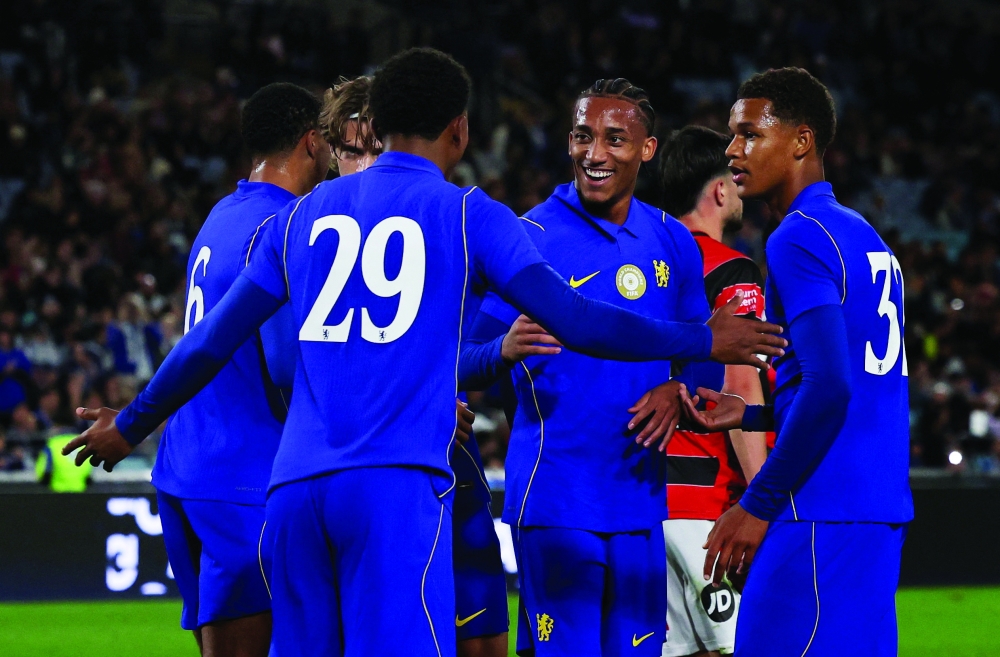 Chelsea's Joao Pedro celebrates scoring their sixth goal with team-mates