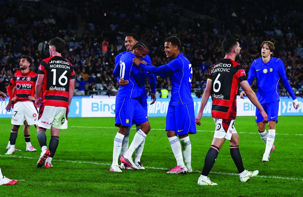 Joao Pedro celebrates scoring their sixth goal with team-mates
