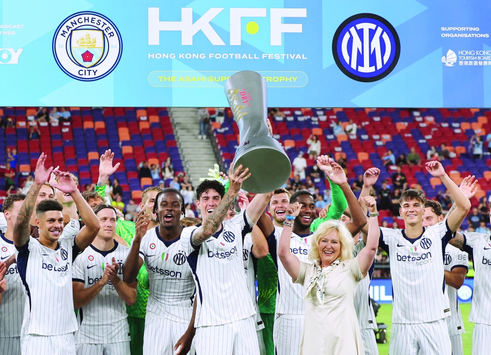 Inter Milan's Alessandro Bastoni lifts the Asahi Super Dry Trophy to celebrate with team-mates. — Reuters