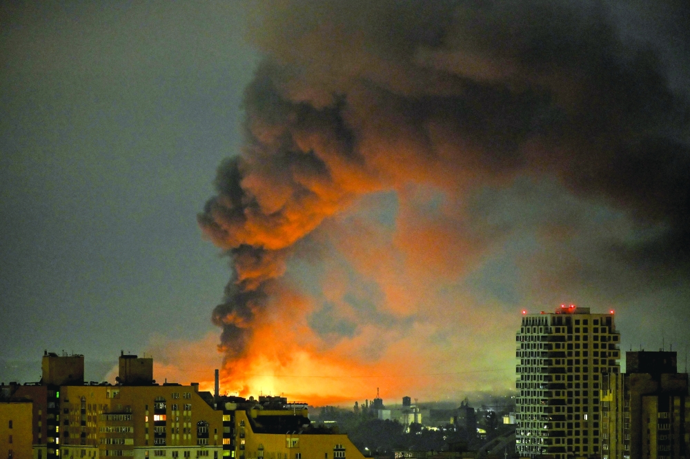 Smoke rises above residential buildings following an air attack in Kyiv. — AFP