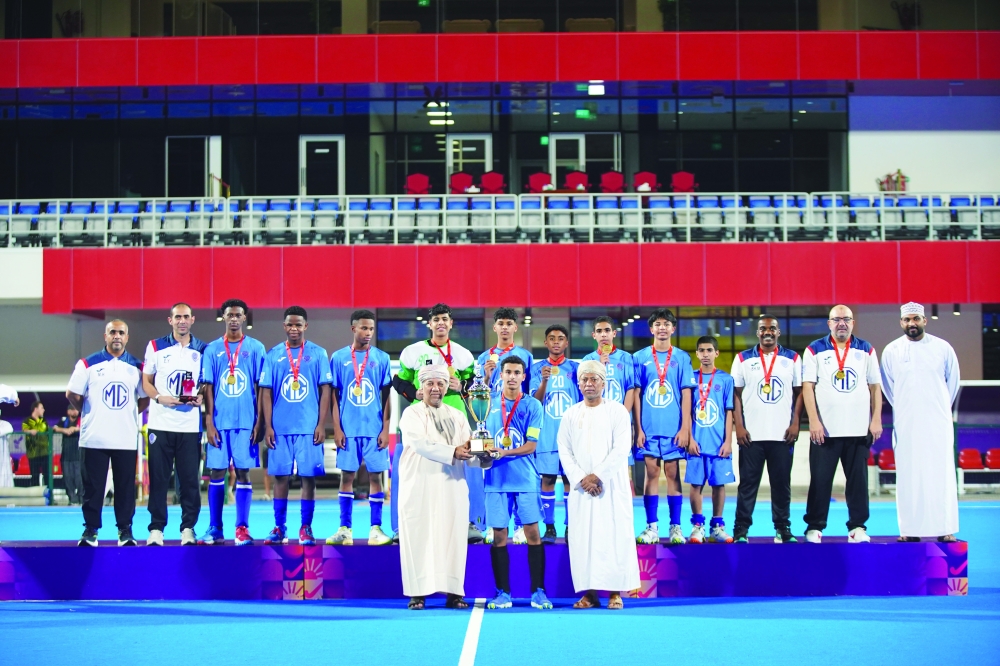 Al Amerat captain receives the championship trophy after the team’s 3-1 final victory.