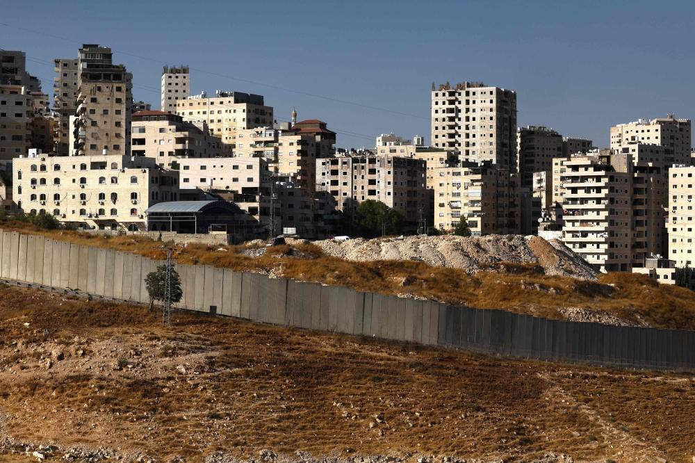 A picture shows a view of the Palestinian Shuafat refugee camp and Israel's controversial separation barrier on August 4, 2026.