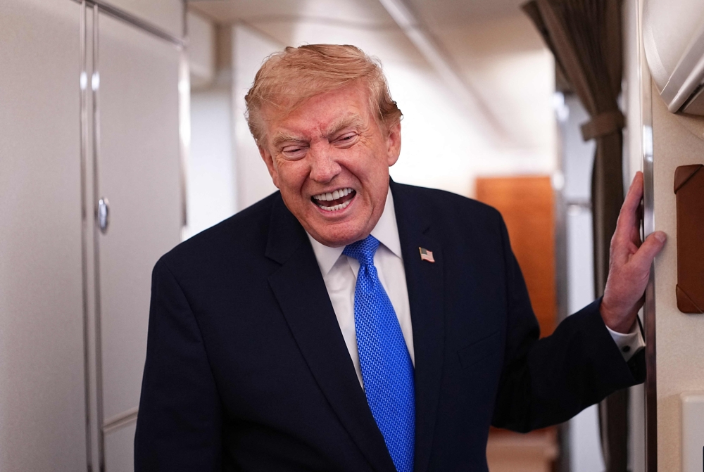  US President Donald Trump speaks to the press aboard Air Force One on August 2, 2026. 