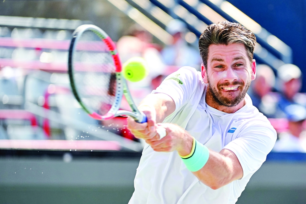 Cameron Norrie (GBR) returns the ball to Alex De Minaur (AUS) in third round play at IGA Stadium. — Imagn Images