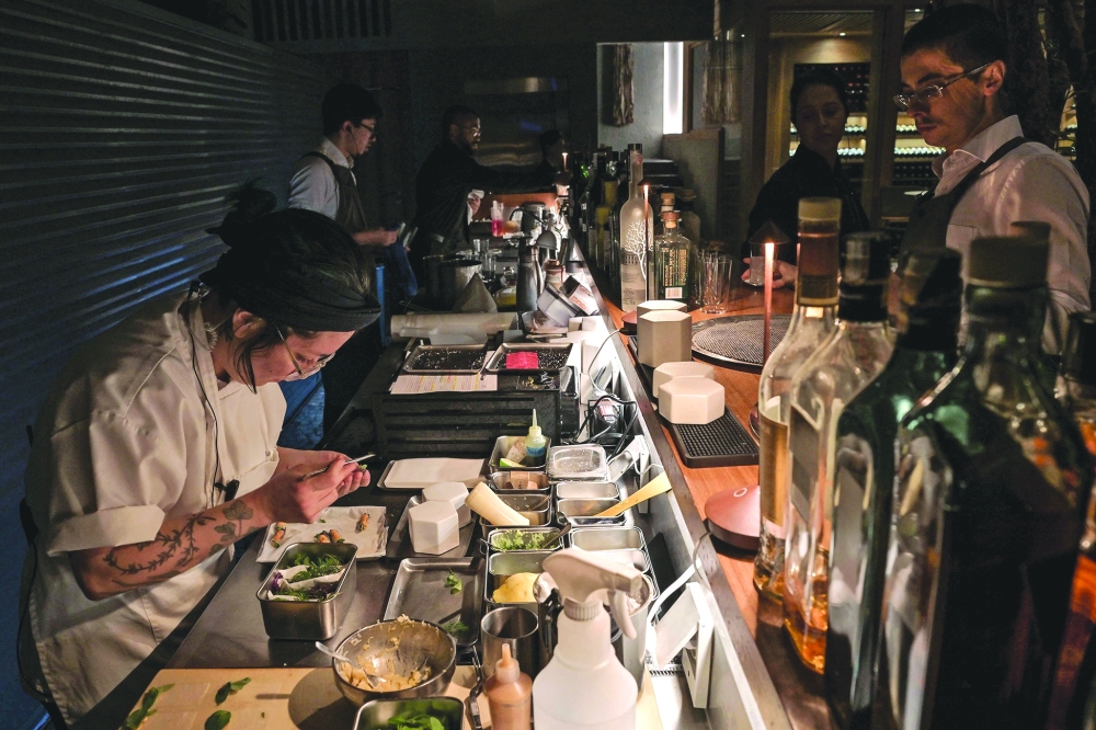 A cook works in TUJU restaurant, the first restaurant in Latin America to receive three Michelin stars. — AFP