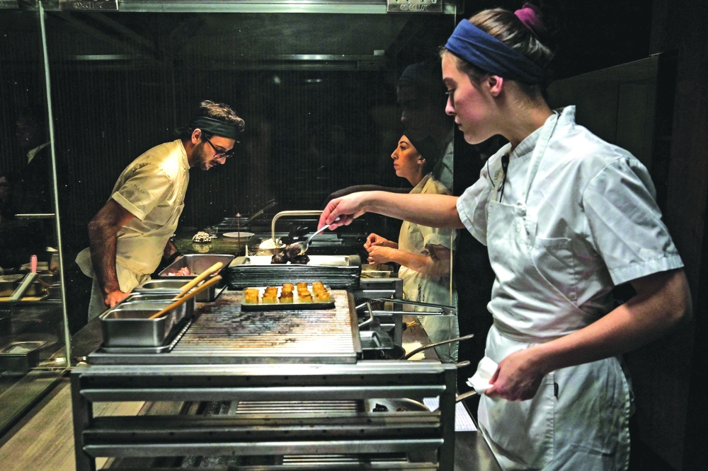 Cooks work in the kitchen of the TUJU restaurant, in Sao Paulo, Brazil, the first restaurant in Latin America to receive three Michelin stars. — AFP