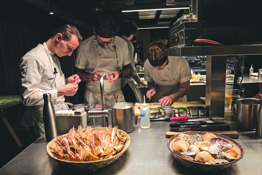 Cooks work in the kitchen of the TUJU restaurant, in Sao Paulo, Brazil, the first restaurant in Latin America to receive three Michelin stars. — AFP