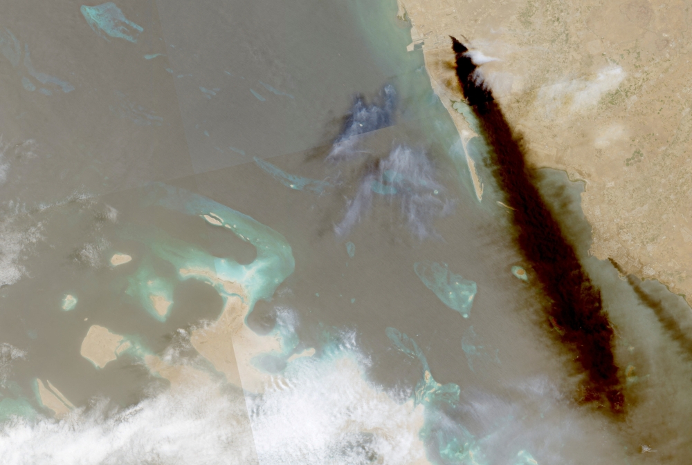 A  satellite image shows a trail of smoke rising from an oil facility in Jizan, Jazan province, Saudi Arabia