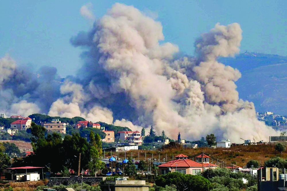 Smoke rises following an Israeli controlled-explosion on the village of Kfartibnit as seen from Nabatieh in southern Lebanon. — AFP