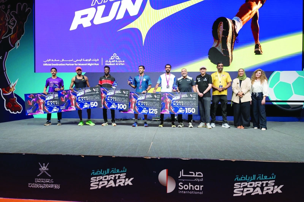 Top finishers pose for a group photo following the conclusion of the Muscat Night Run.