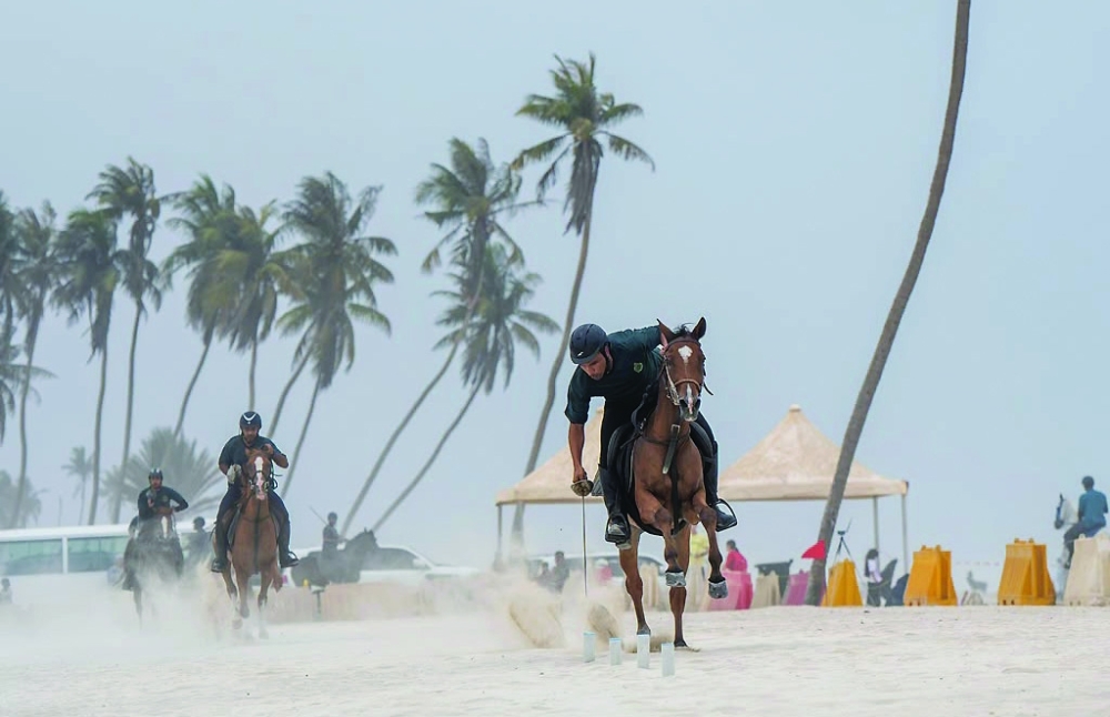 A rider demonstrates skill and accuracy in the lemons and peg competition at Al Haffa Beach.