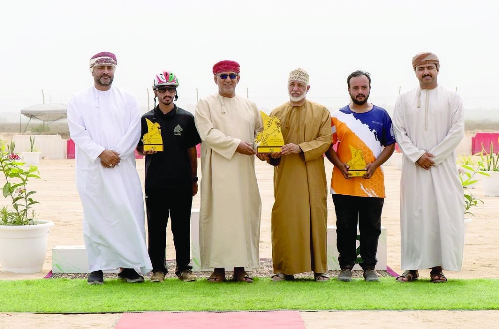 Winners and officials celebrate at the conclusion of the Khareef Dhofar 100km Endurance Race.