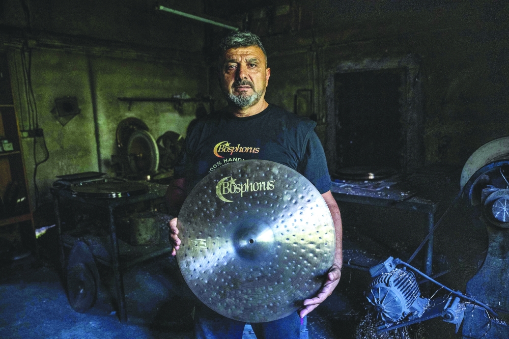 Hasan Seker, a 56-year-old who co-founded Bosphorus Cymbals, poses at a traditional workshop in Istanbul — AFP