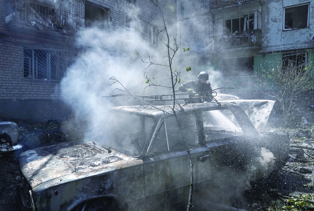 A firefighter works at a site of an apartment building damaged during a Russian air strike in Zaporizhzhia, Ukraine. — Reuters 