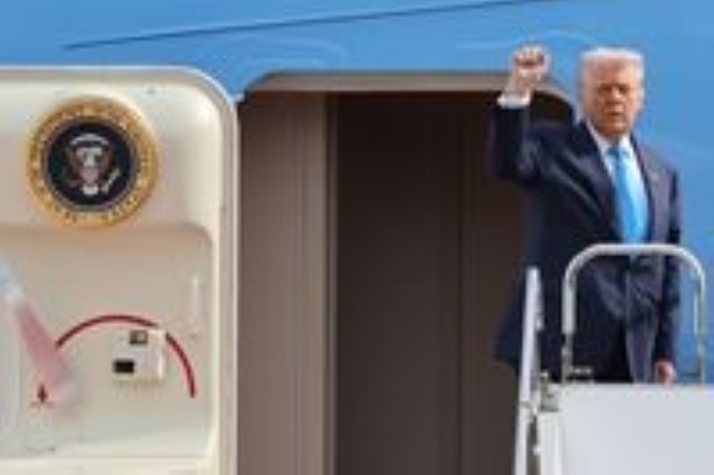U.S. President Donald Trump gestures as he boards Air Force One