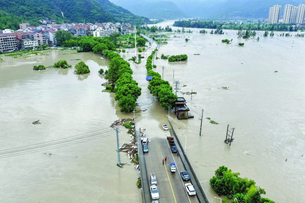 A drone view shows roads and village houses partially submerged in floodwaters, following heavy rainfall brought by Typhoon Dolphin, in Yantou town, Yongjia county, Wenzhou, Zhejiang province, China August 10, 2026. China Daily via REUTERS